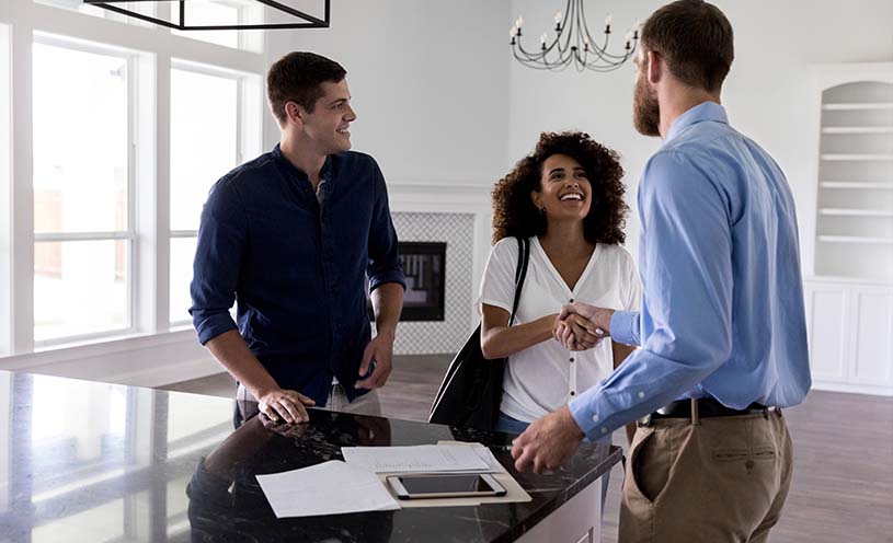 Couple meets male realtor at an empty home