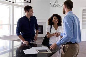 Couple meets male realtor at an empty home