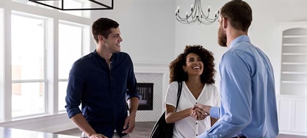 Couple meets male realtor at an empty home