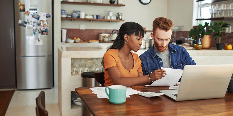 Couple Looking at Expenses on computer