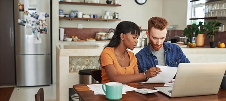 Couple Looking at Expenses on computer