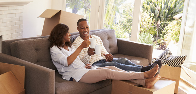 Two first-time homebuyers enjoying their first day in their new home. 